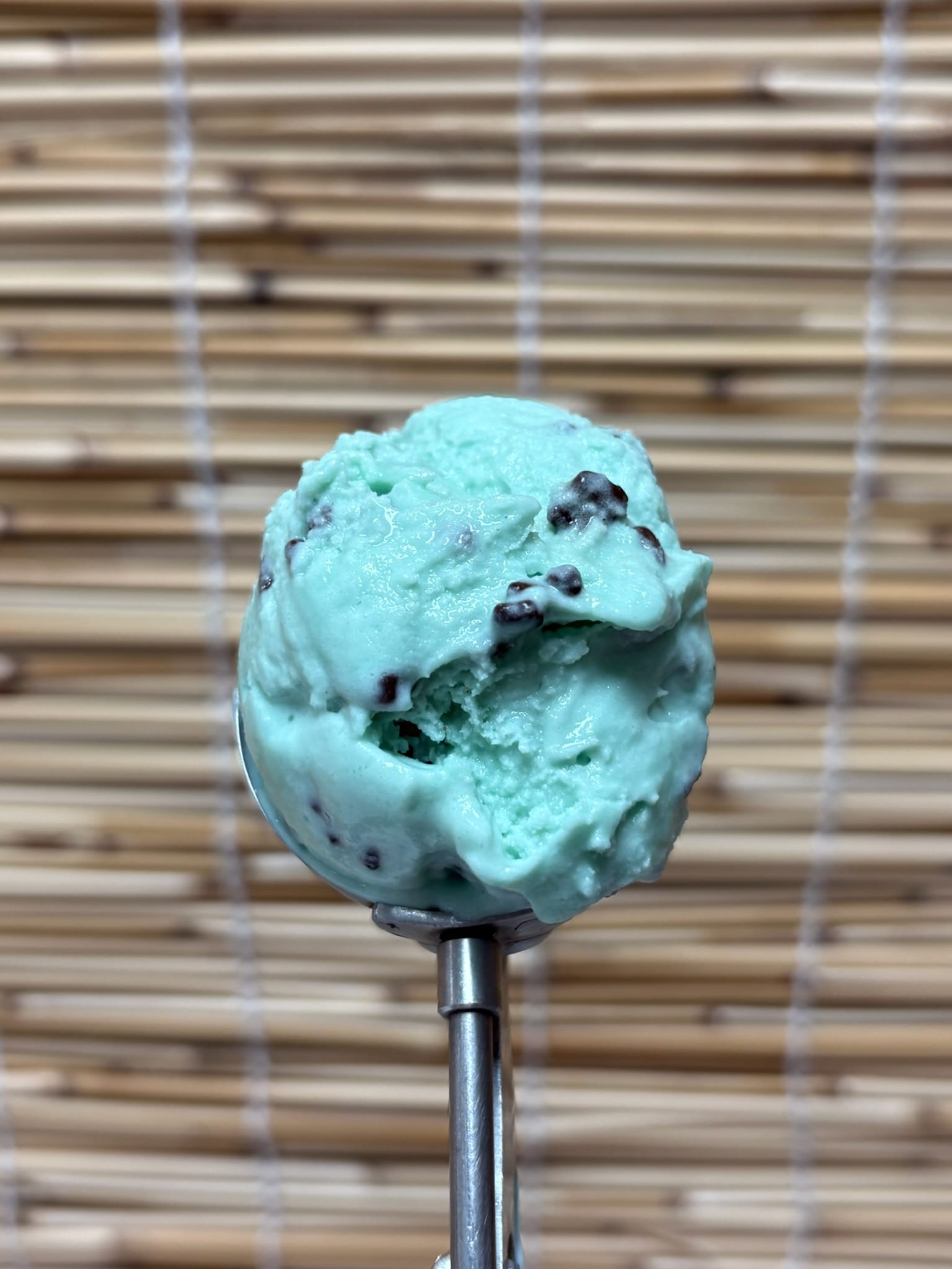 Scooping a fresh ball of artisan ice cream