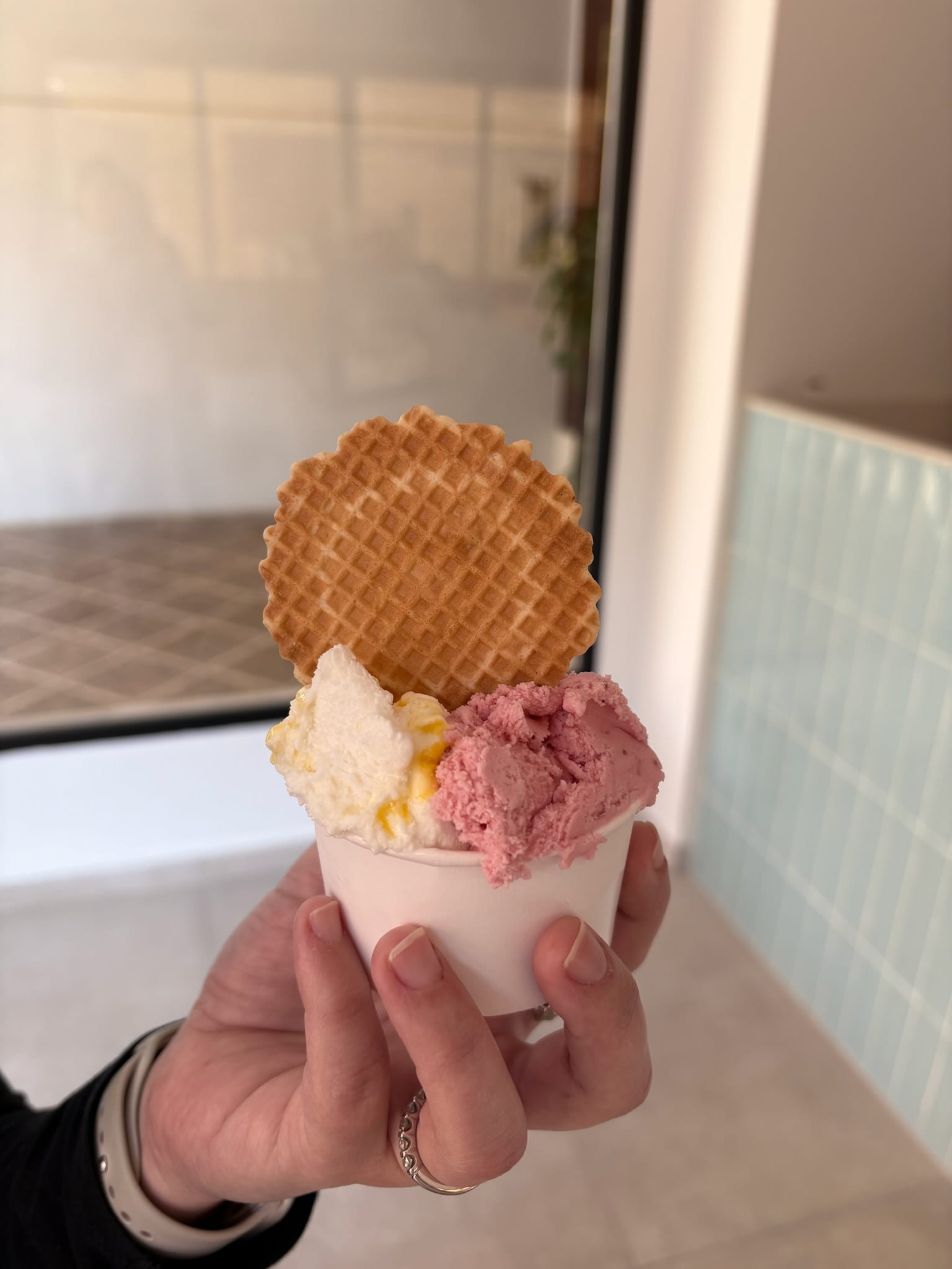 Artisan ice cream cup with several scoops and toppings