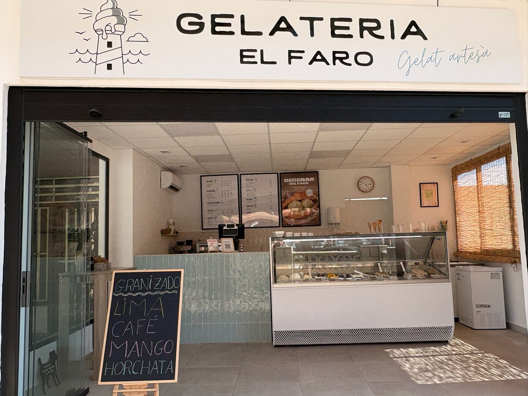 Daytime front of Gelateria El Faro with chalkboard "Granizado lima café mango horchata"